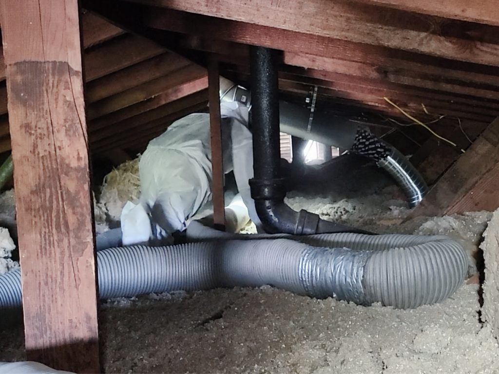 AtticXperts technician preparing crawl space service work